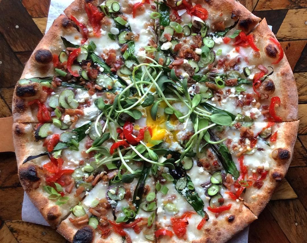 Veggie pizza with pea sprouts