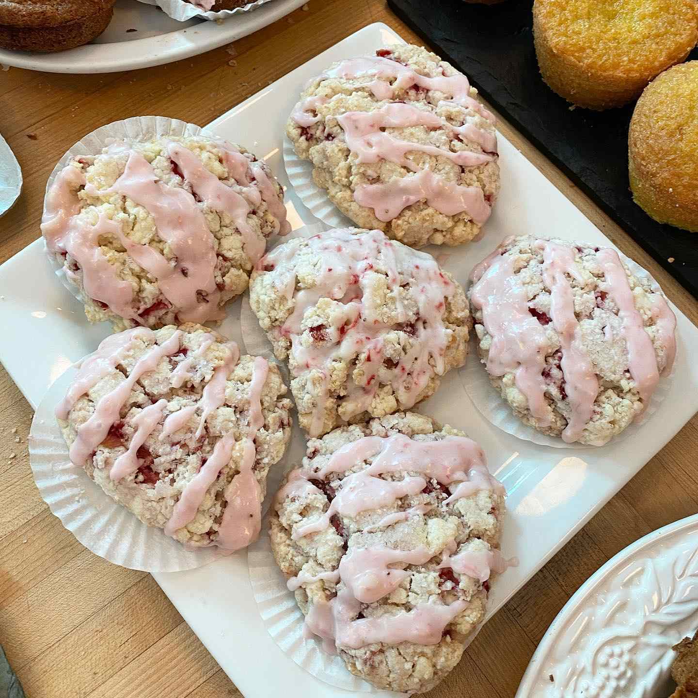 Golden scones with strawberry icing.
