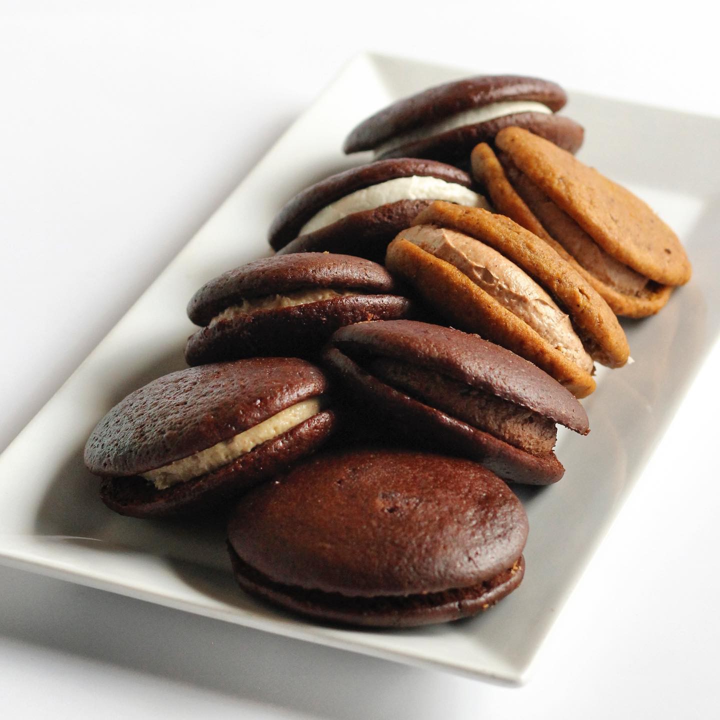Chocolate gobs on a white plate.