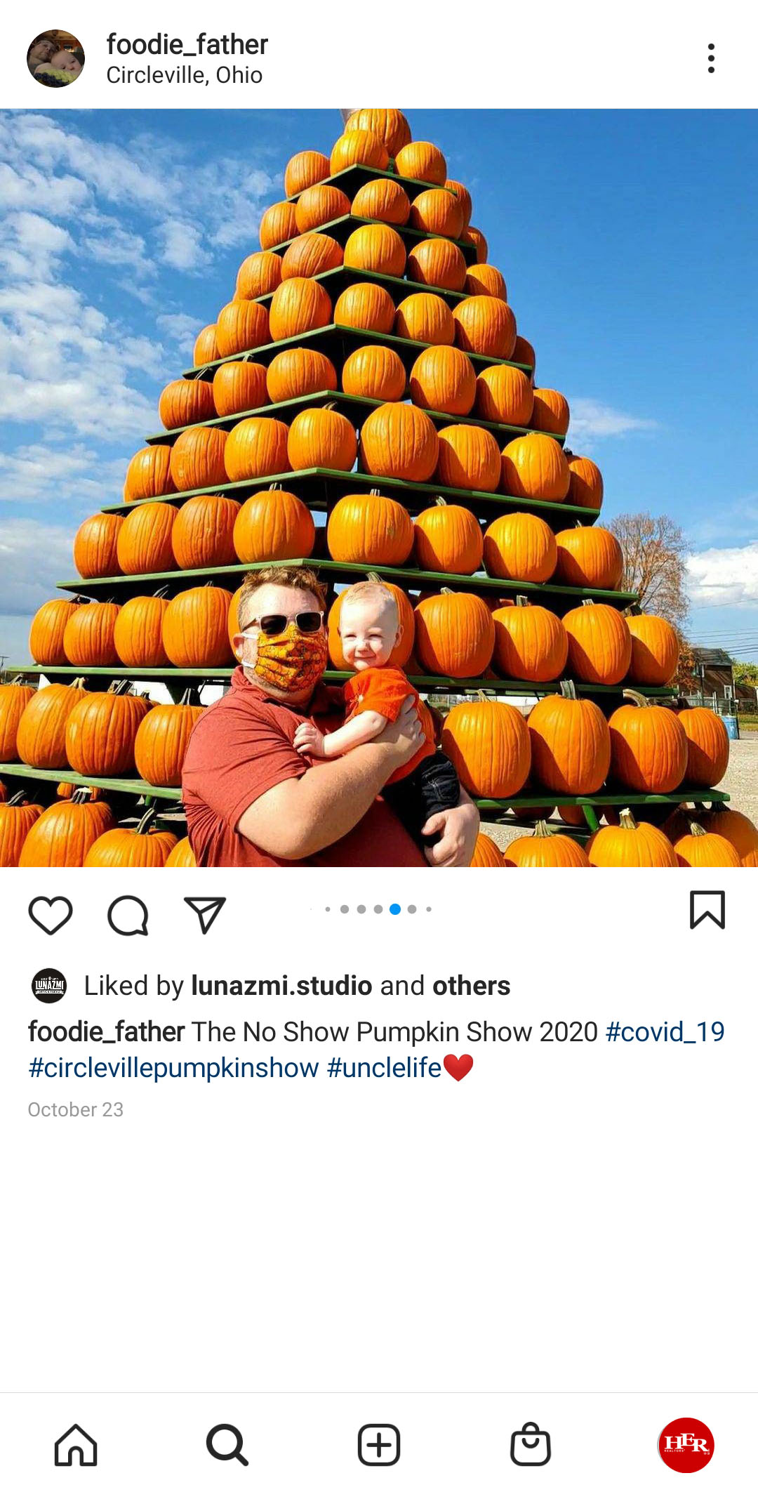 A man with his baby at pumpkin show