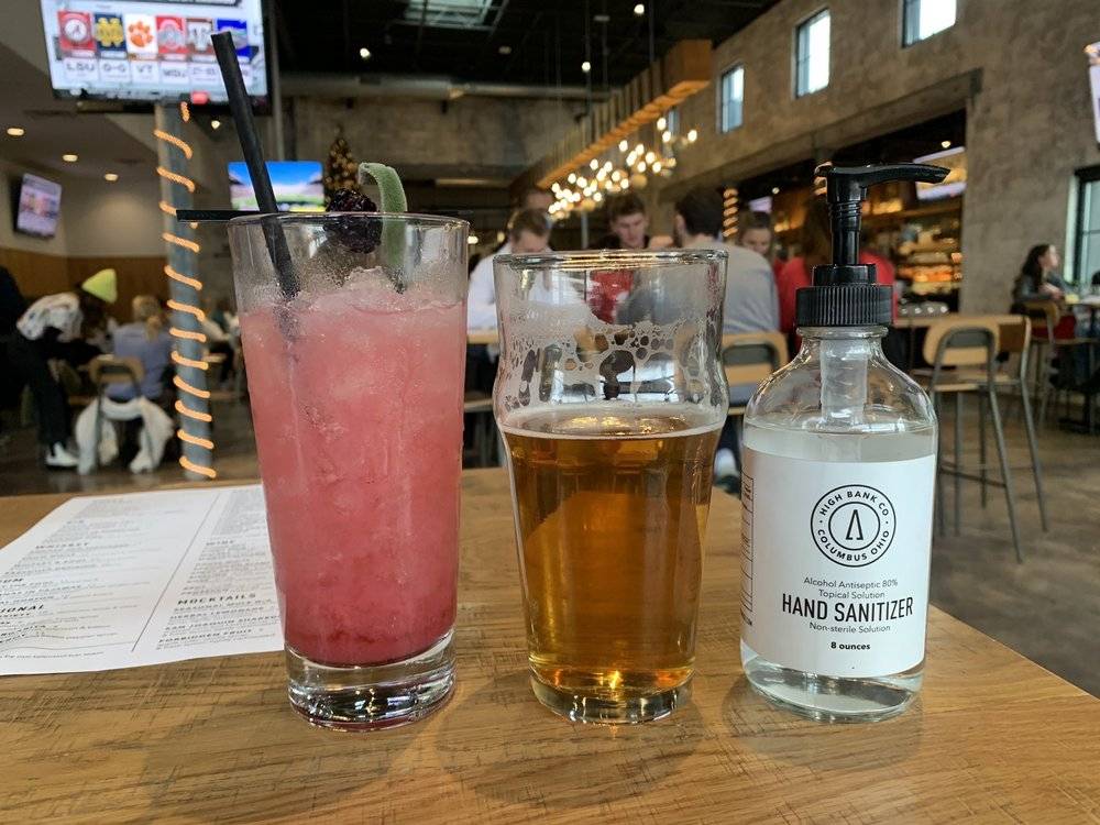 A picture depicting High Bank Distillery's beautiful environment, sanitary tables, and colorful drinks!
