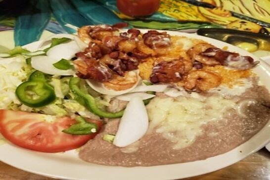 Mexican rice with shrimp, refried beans, and a salad.