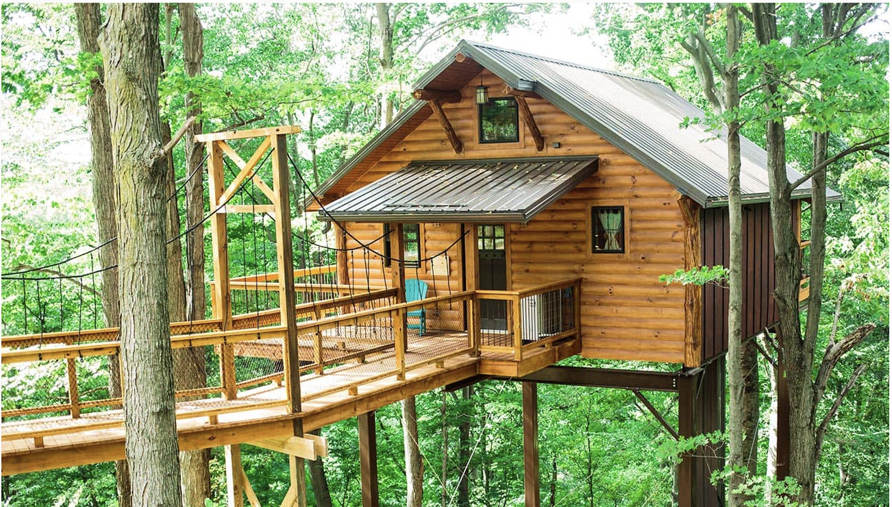A cabin treehouse and wooden ramp placed high in the trees