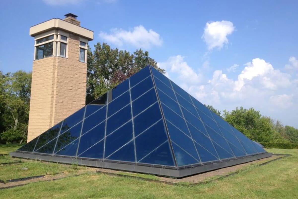 Glass pyramid skylight roof of Ohio's Pyramid House, along with chimney/viewing tower right next to it