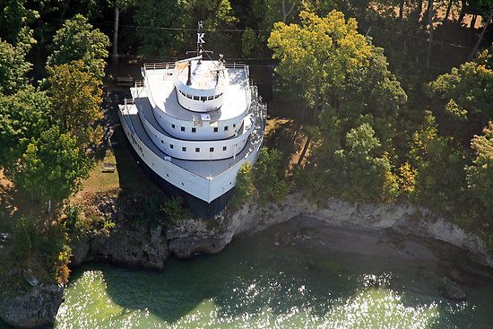 Large front-half of a cargo ship converted into an immobile houseship on the bay