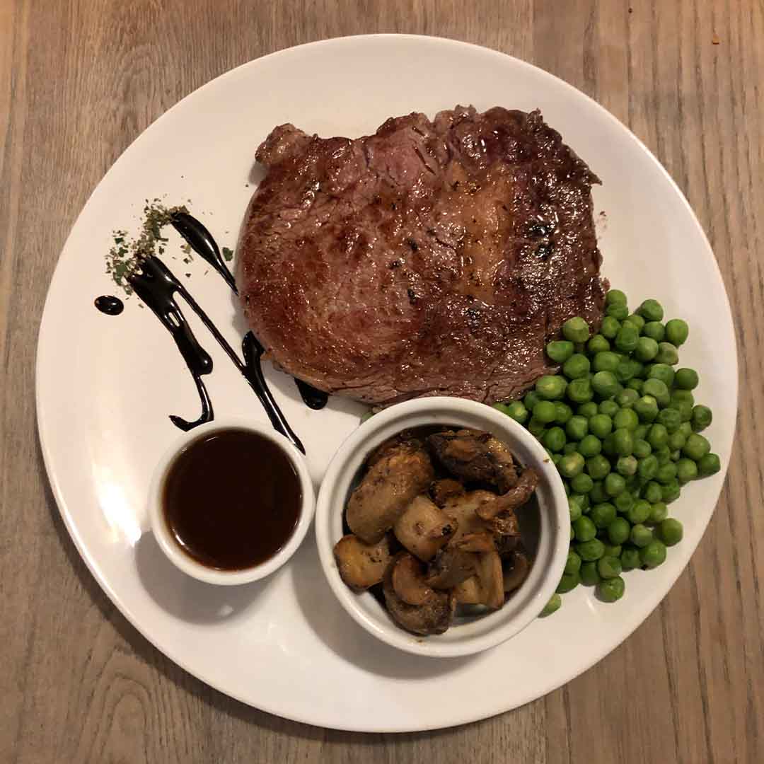 Falcon Steakhouse 10oz rump steak with peas, mushrooms and famous beef sauce