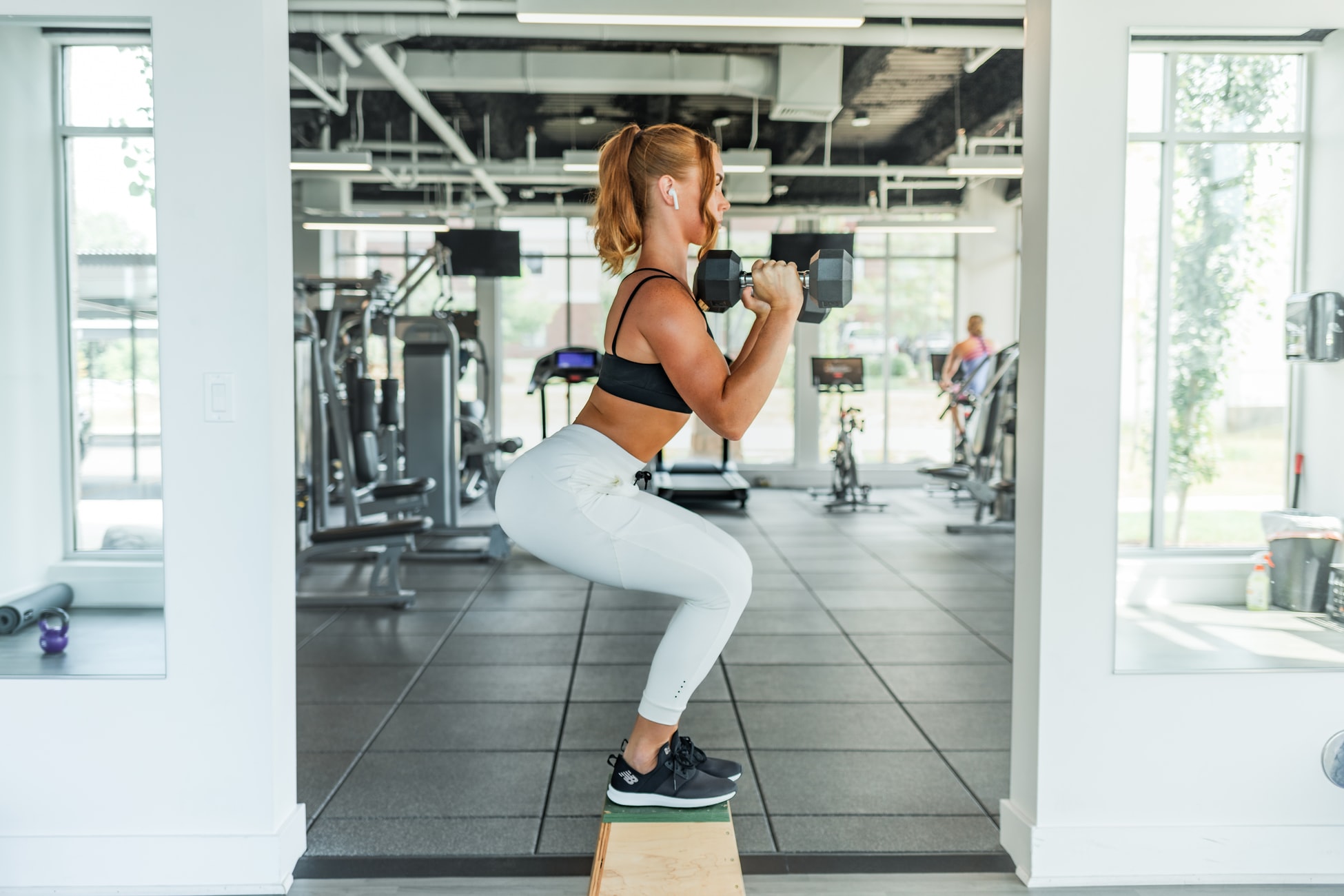 Woman Doing Squats In Gym