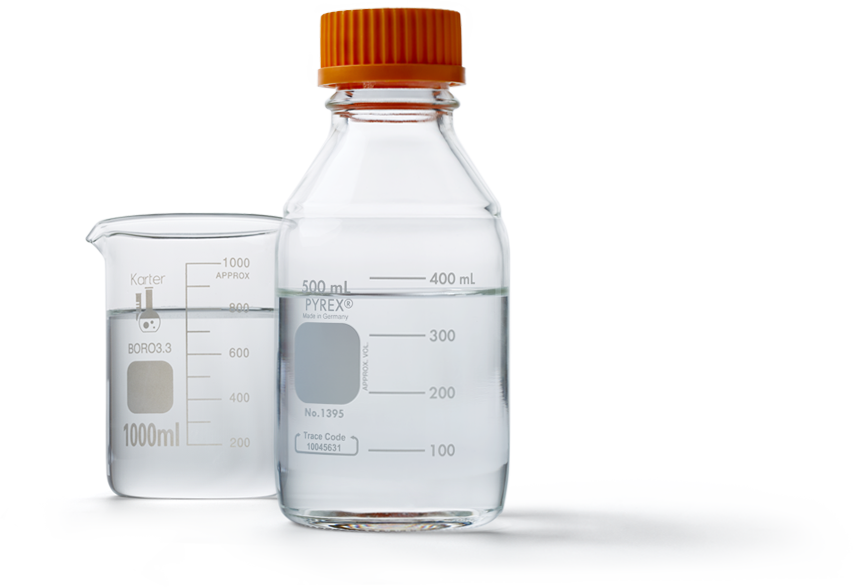 Laboratory flask and bottle containing clear liquid