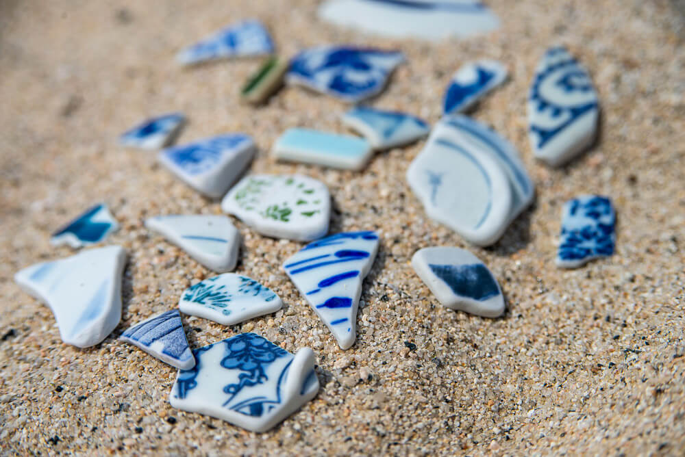 Broken pieces of Japanese teaware that can be found all along the beach