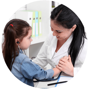 Nurse letting little girl use stethoscope to hear her own heartbeat.