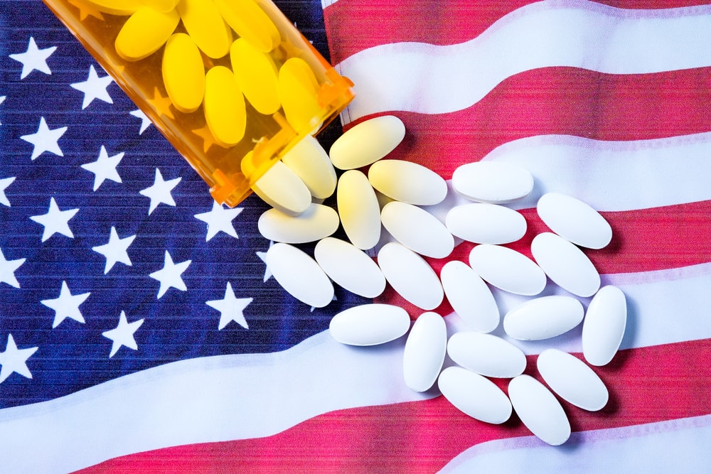 Opioid pills on American flag background