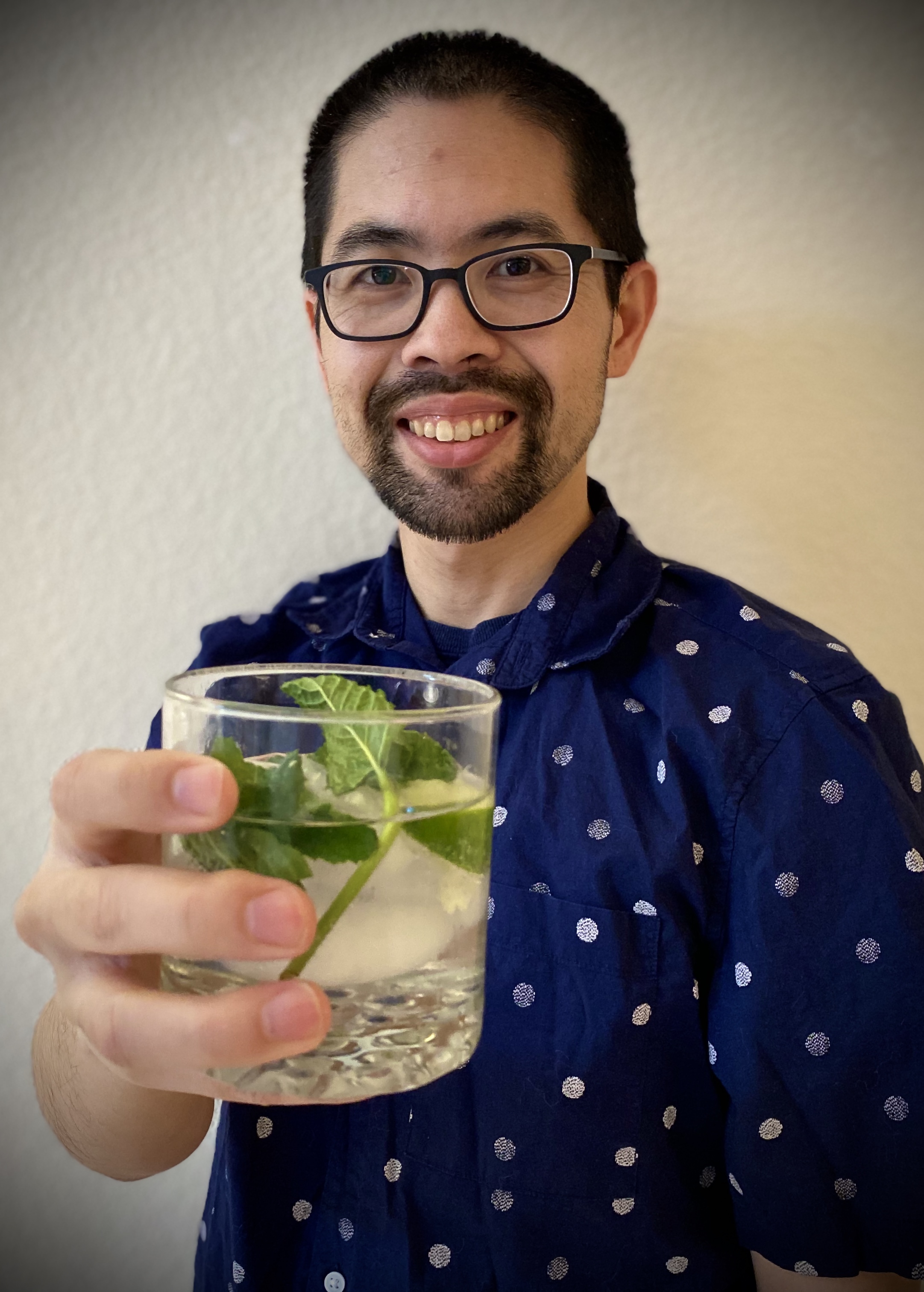 Me holding a cocktail out to the viewer.