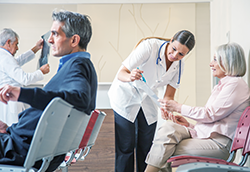 Caring, attentive nurse helping a patient understand appointment information