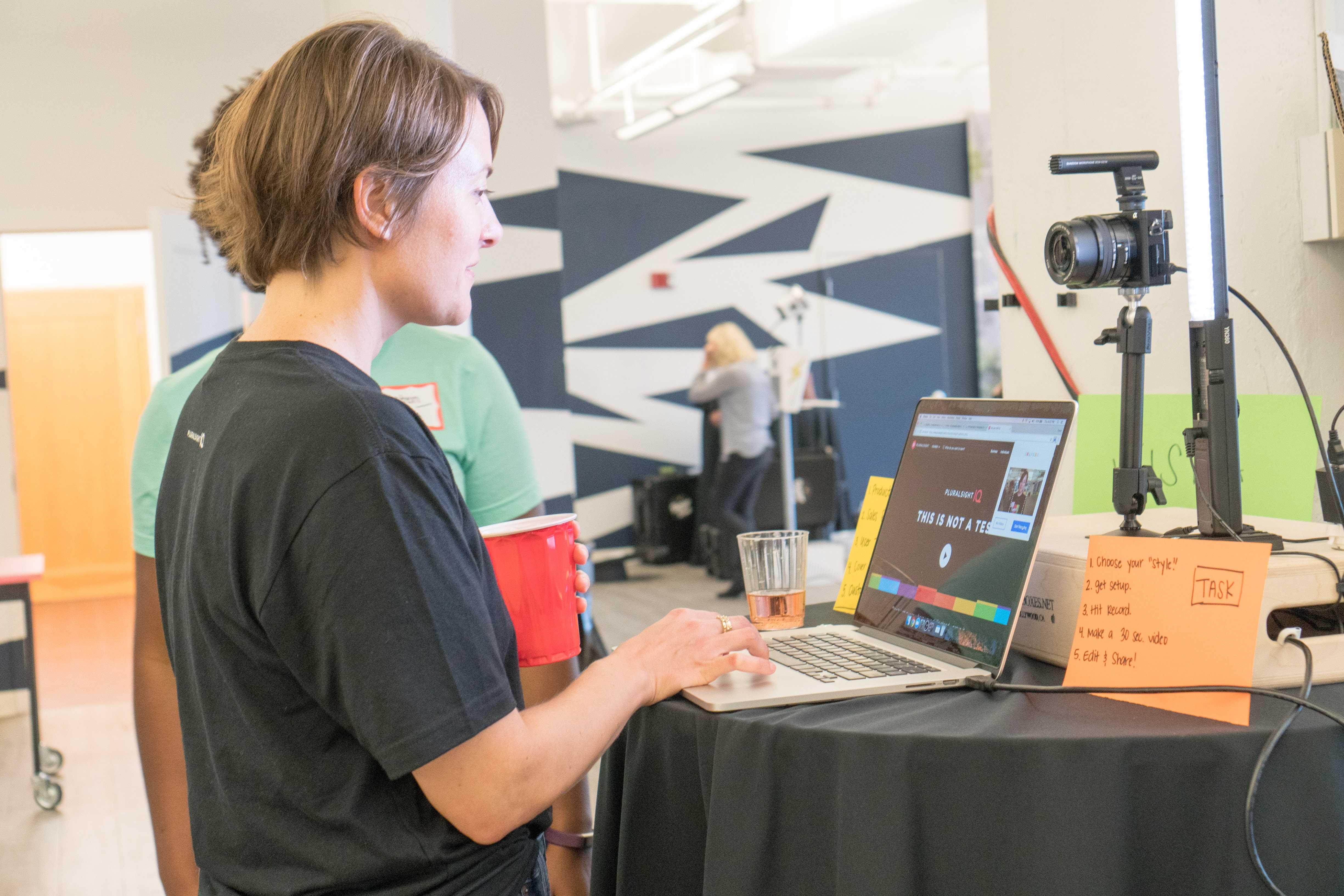 A woman is recorded while testing a product on a laptop