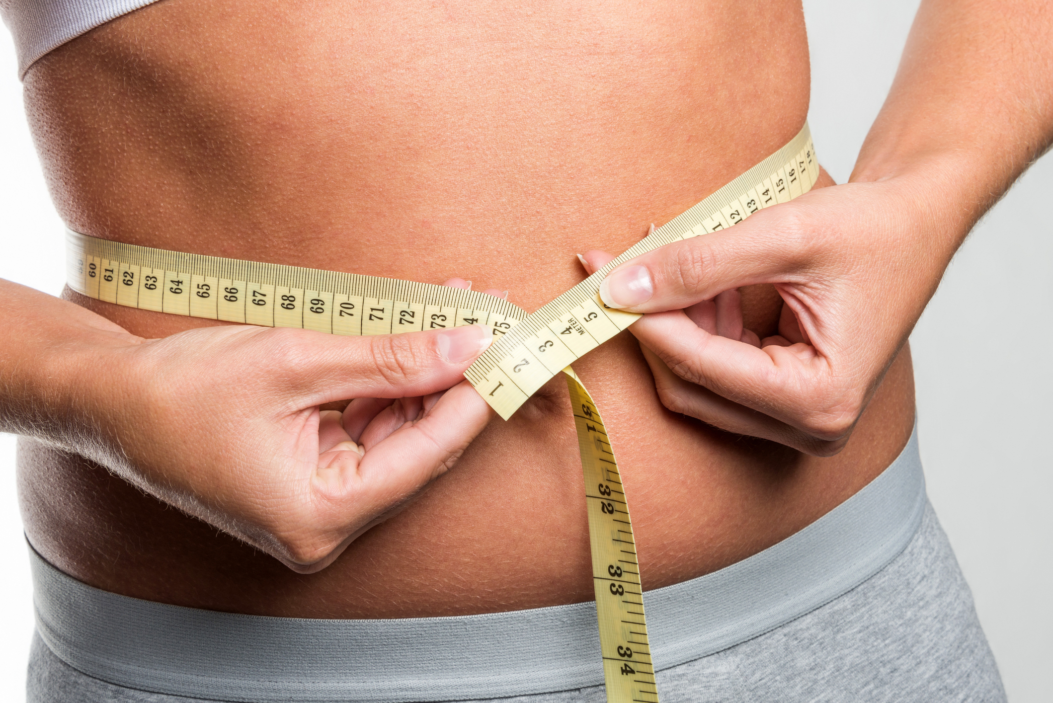 taking waist measurement with a tape measure