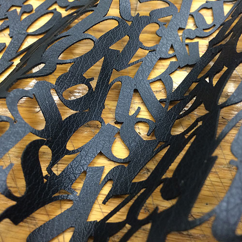 laser cut typographic material in waves.