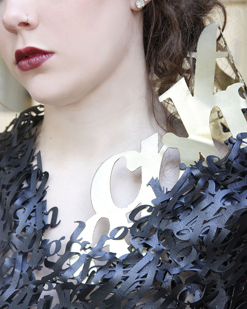 close up of leather typographic top and metal typography colllar.