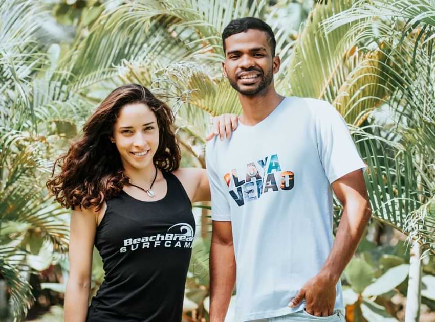 A girl with BeachBreak surf camp t-shirt with a man with a Playa Venao shirt.