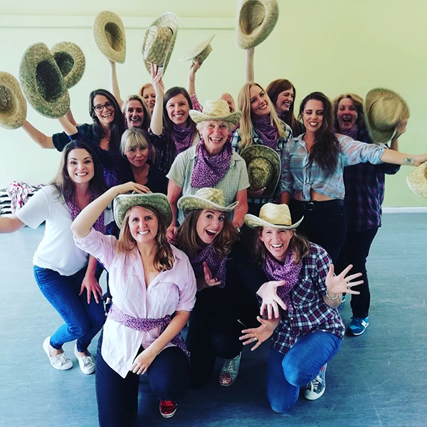 Amy Young line dance hen party in Bath. Women wearing cowgirl hats.