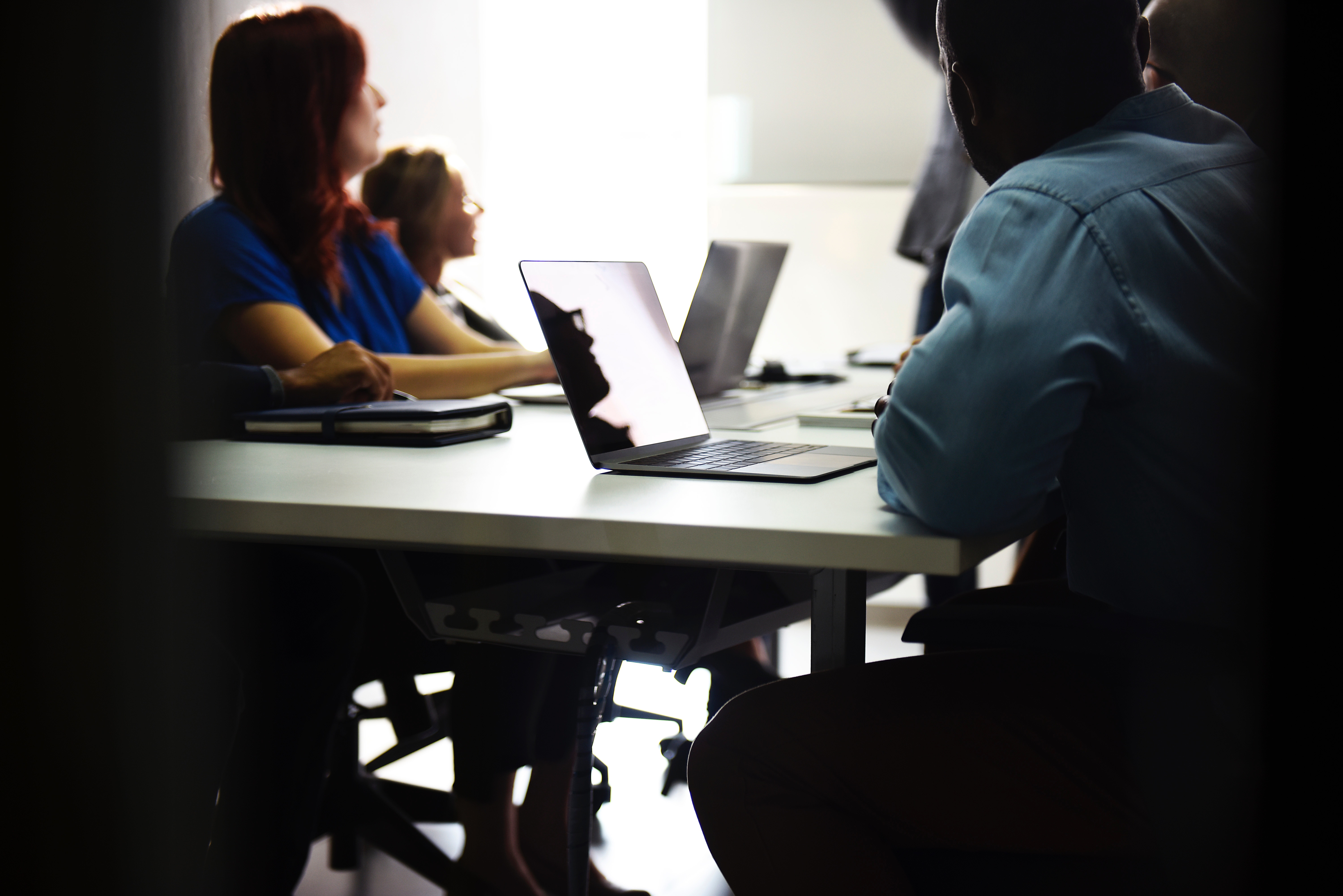 people with laptops at a table