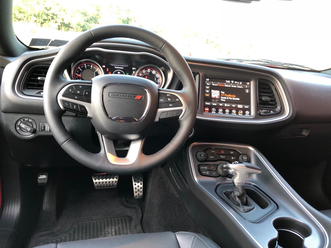 a photograph showing the steering wheel and dash of steve brice's 2018 dodge challenger
