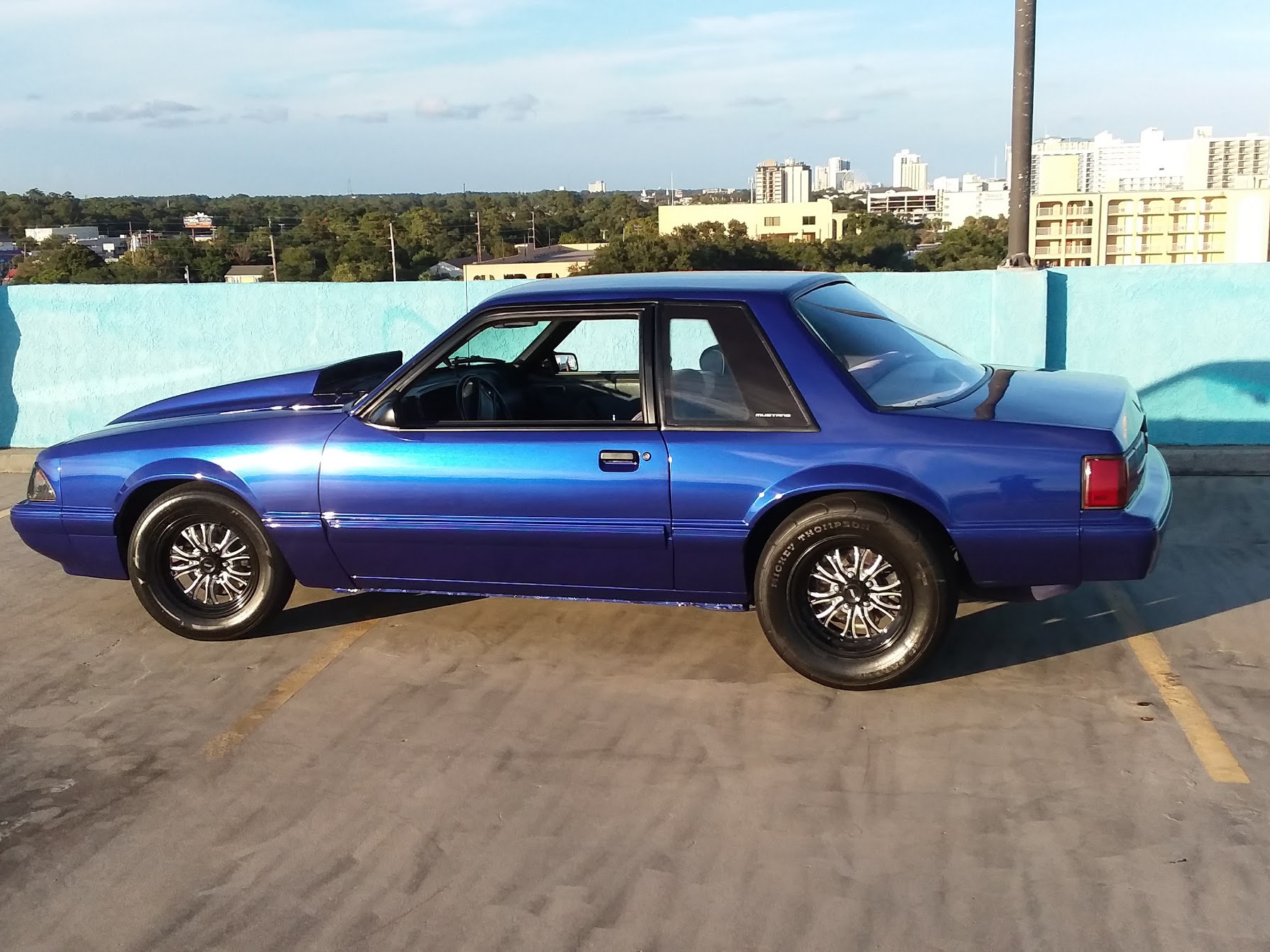 1987 blue ford mustang side view