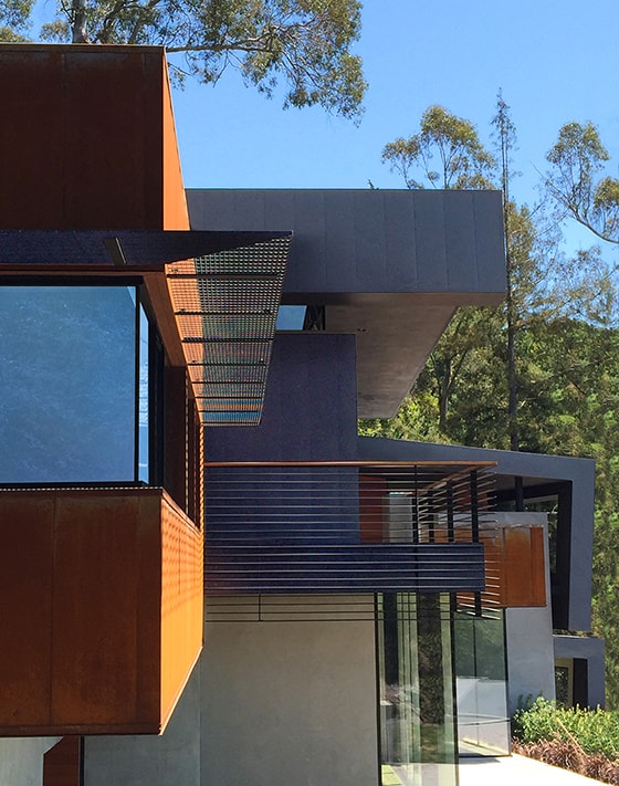 Designed for a tech entrepreneur couple and their young twins, the home in Mill Valley, California is a modern composition in articulated form. Located on a large wooded canyon site and sharing the land with a family of nesting red-tail hawks, this residence is designed to integrate into the landscape through cascading forms and natural materials. The exterior is a montage of natural wood, oxidized steel, and rich zinc panels blending with the surrounding foliage with many of these materials utilized on the interiors as well blurring the lines between inside and out. The main feature of the house is an observatory for the nesting raptors in the tree above visible through the upper level roofs to connect the interior to the beautiful natural surroundings.