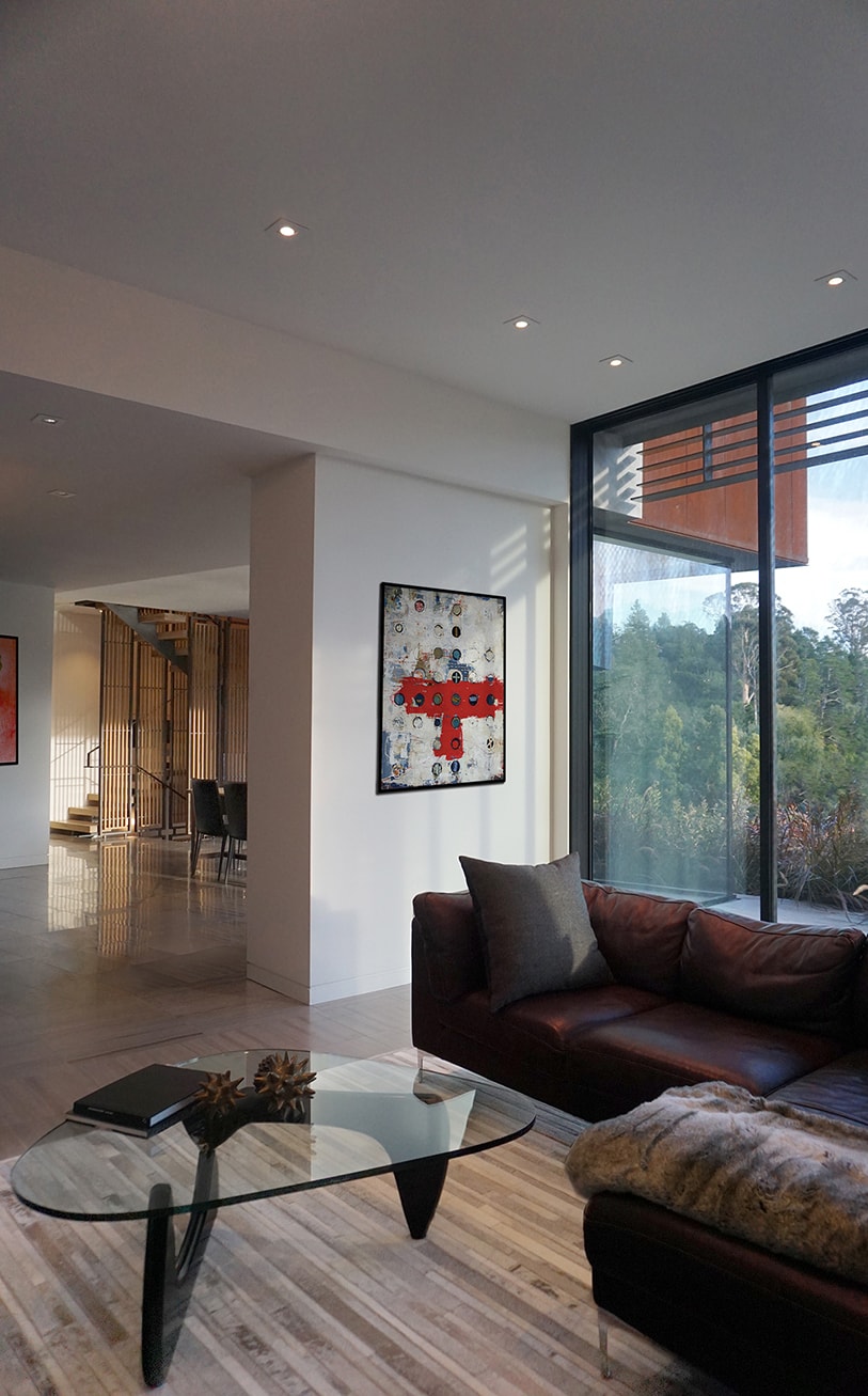 Designed for a tech entrepreneur couple and their young twins, the home in Mill Valley, California is a modern composition in articulated form. Located on a large wooded canyon site and sharing the land with a family of nesting red-tail hawks, this residence is designed to integrate into the landscape through cascading forms and natural materials. The exterior is a montage of natural wood, oxidized steel, and rich zinc panels blending with the surrounding foliage with many of these materials utilized on the interiors as well blurring the lines between inside and out. The main feature of the house is an observatory for the nesting raptors in the tree above visible through the upper level roofs to connect the interior to the beautiful natural surroundings.