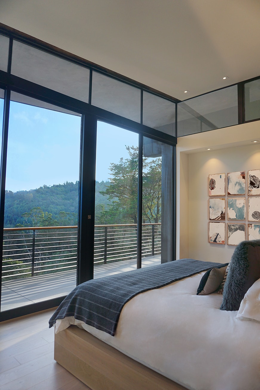 Designed for a tech entrepreneur couple and their young twins, the home in Mill Valley, California is a modern composition in articulated form. Located on a large wooded canyon site and sharing the land with a family of nesting red-tail hawks, this residence is designed to integrate into the landscape through cascading forms and natural materials. The exterior is a montage of natural wood, oxidized steel, and rich zinc panels blending with the surrounding foliage with many of these materials utilized on the interiors as well blurring the lines between inside and out. The main feature of the house is an observatory for the nesting raptors in the tree above visible through the upper level roofs to connect the interior to the beautiful natural surroundings.