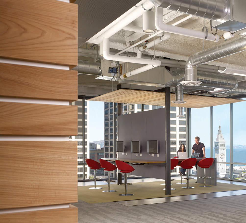QA was commissioned to design the new corporate headquarters for New Relic, the fast-growing industry leader in Data Analytics for App Monitoring. Custom pen Collaborative Areas are located in the floor’s corners for quick informal meetings and impromptu mini-workstations for staff visiting other departments. The most dynamic space within the four full floors of offices is the large Café and All Hands Area that accommodates informal meetings, all-office presentations, and interactive interoffice social functions. The palette for New Relic was derived from the image invoked by its name- the juxtaposition of old and new, modern and decayed. Using reclaimed old growth elm, the wood is mingled amongst flamed steel walls, perforated metal panels and colorful furniture to create a warm, lively, and inviting work place. We are honored and excited that our design for the New Relic Headquarters was selected by the SF Business Times as one of the top "10 Coolest Offices in the Bay Area 2018."