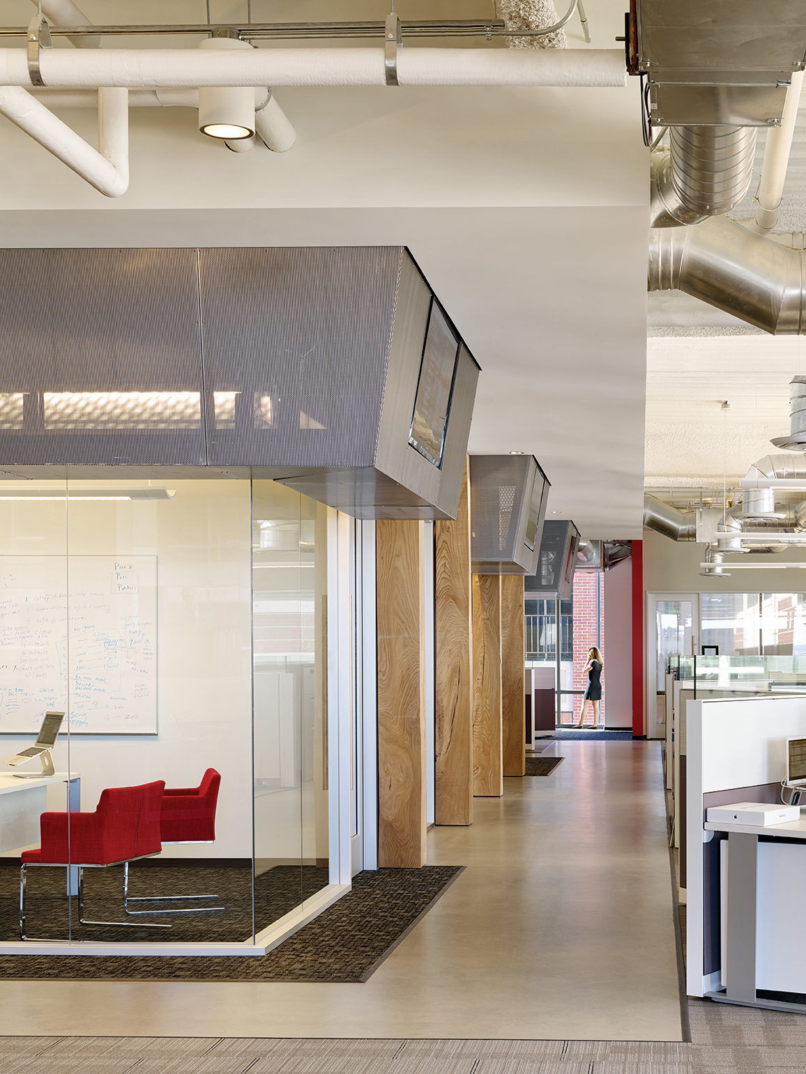 QA was commissioned to design the new corporate headquarters for New Relic, the fast-growing industry leader in Data Analytics for App Monitoring. Custom pen Collaborative Areas are located in the floor’s corners for quick informal meetings and impromptu mini-workstations for staff visiting other departments. The most dynamic space within the four full floors of offices is the large Café and All Hands Area that accommodates informal meetings, all-office presentations, and interactive interoffice social functions. The palette for New Relic was derived from the image invoked by its name- the juxtaposition of old and new, modern and decayed. Using reclaimed old growth elm, the wood is mingled amongst flamed steel walls, perforated metal panels and colorful furniture to create a warm, lively, and inviting work place. We are honored and excited that our design for the New Relic Headquarters was selected by the SF Business Times as one of the top "10 Coolest Offices in the Bay Area 2018."