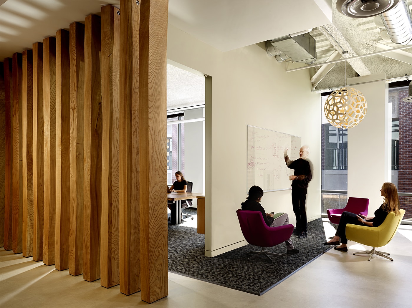 QA was commissioned to design the new corporate headquarters for New Relic, the fast-growing industry leader in Data Analytics for App Monitoring. Custom pen Collaborative Areas are located in the floor’s corners for quick informal meetings and impromptu mini-workstations for staff visiting other departments. The most dynamic space within the four full floors of offices is the large Café and All Hands Area that accommodates informal meetings, all-office presentations, and interactive interoffice social functions. The palette for New Relic was derived from the image invoked by its name- the juxtaposition of old and new, modern and decayed. Using reclaimed old growth elm, the wood is mingled amongst flamed steel walls, perforated metal panels and colorful furniture to create a warm, lively, and inviting work place. We are honored and excited that our design for the New Relic Headquarters was selected by the SF Business Times as one of the top "10 Coolest Offices in the Bay Area 2018."
