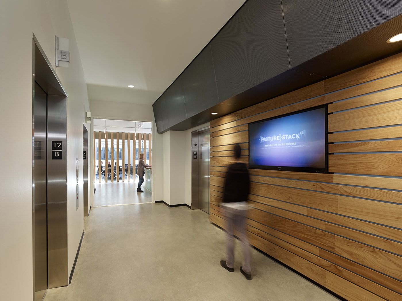 QA was commissioned to design the new corporate headquarters for New Relic, the fast-growing industry leader in Data Analytics for App Monitoring. Custom pen Collaborative Areas are located in the floor’s corners for quick informal meetings and impromptu mini-workstations for staff visiting other departments. The most dynamic space within the four full floors of offices is the large Café and All Hands Area that accommodates informal meetings, all-office presentations, and interactive interoffice social functions. The palette for New Relic was derived from the image invoked by its name- the juxtaposition of old and new, modern and decayed. Using reclaimed old growth elm, the wood is mingled amongst flamed steel walls, perforated metal panels and colorful furniture to create a warm, lively, and inviting work place. We are honored and excited that our design for the New Relic Headquarters was selected by the SF Business Times as one of the top "10 Coolest Offices in the Bay Area 2018."
