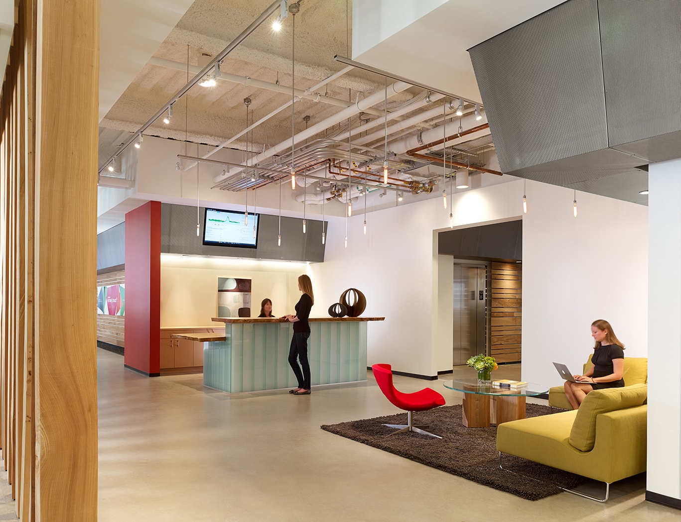QA was commissioned to design the new corporate headquarters for New Relic, the fast-growing industry leader in Data Analytics for App Monitoring. Custom pen Collaborative Areas are located in the floor’s corners for quick informal meetings and impromptu mini-workstations for staff visiting other departments. The most dynamic space within the four full floors of offices is the large Café and All Hands Area that accommodates informal meetings, all-office presentations, and interactive interoffice social functions. The palette for New Relic was derived from the image invoked by its name- the juxtaposition of old and new, modern and decayed. Using reclaimed old growth elm, the wood is mingled amongst flamed steel walls, perforated metal panels and colorful furniture to create a warm, lively, and inviting work place. We are honored and excited that our design for the New Relic Headquarters was selected by the SF Business Times as one of the top "10 Coolest Offices in the Bay Area 2018."