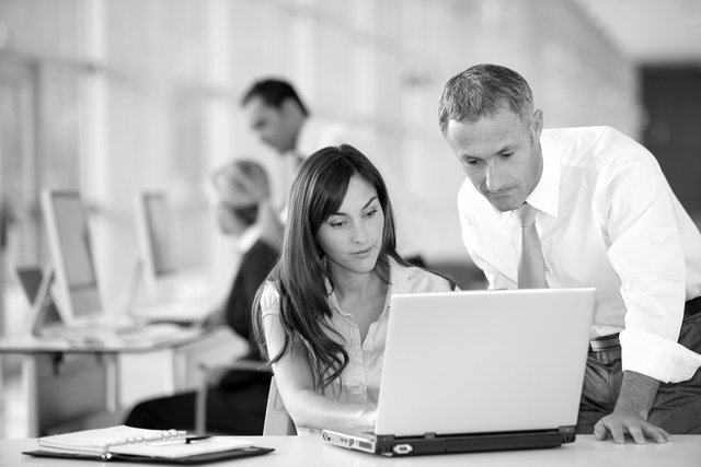 man and woman looking at a computer screen