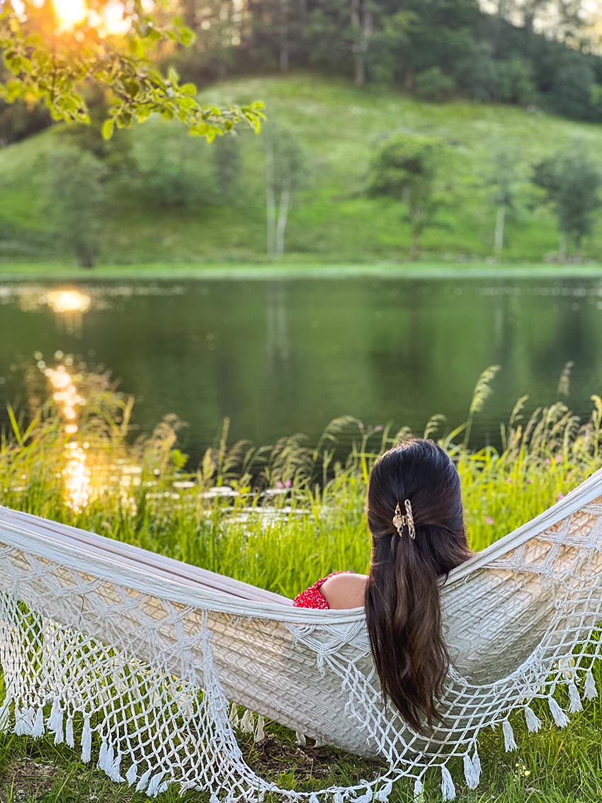Woman relaxing near the lake at Solneset Gård outside Bergen, Norway