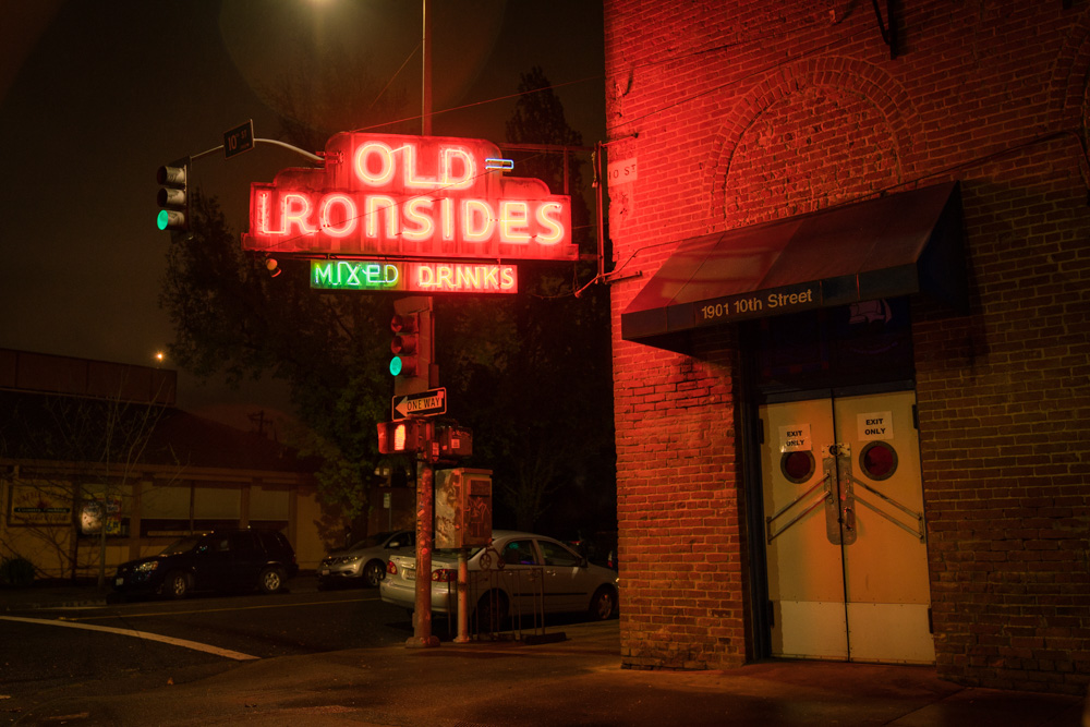 A neon light shines outside of Old Ironsides in Midtown Sacramento for Visit Sacramento.
