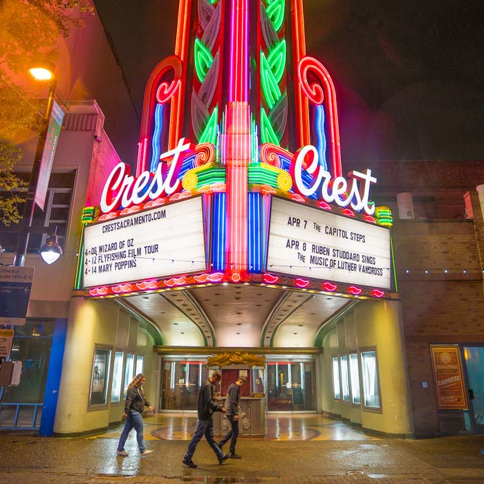 A neon light on the facade of Crest Theatre in Downtown for Visit Sacramento.