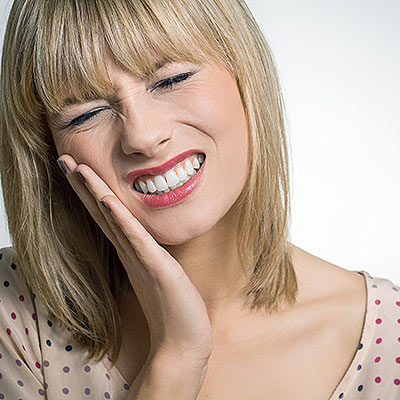 Photo of Woman appearing to be in mouth pain