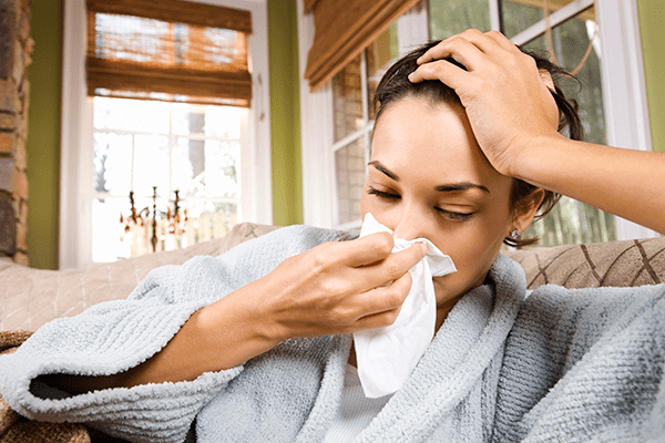 Woman suffering from symptoms of nasal polyps.