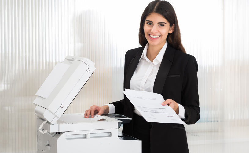 businesswoman completing some photocopier servicing