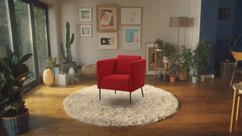 This is a gif of an augmented reality app from IKEA. The IKEA app uses AR to let users see furniture in their home. The gif shows a rotating sequence of multiple chairs in a living room with cactuses and natural light.