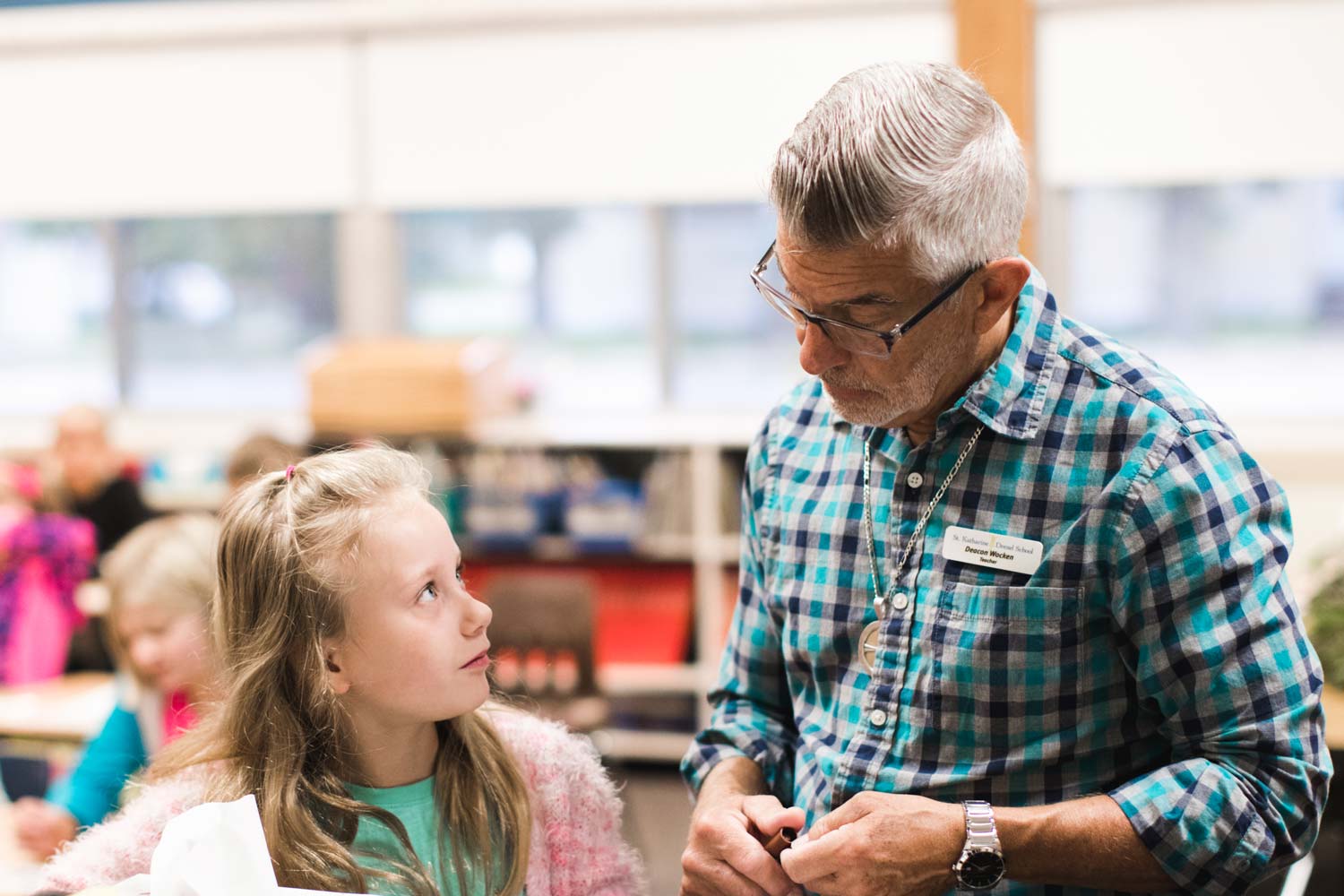 Teacher helping student.