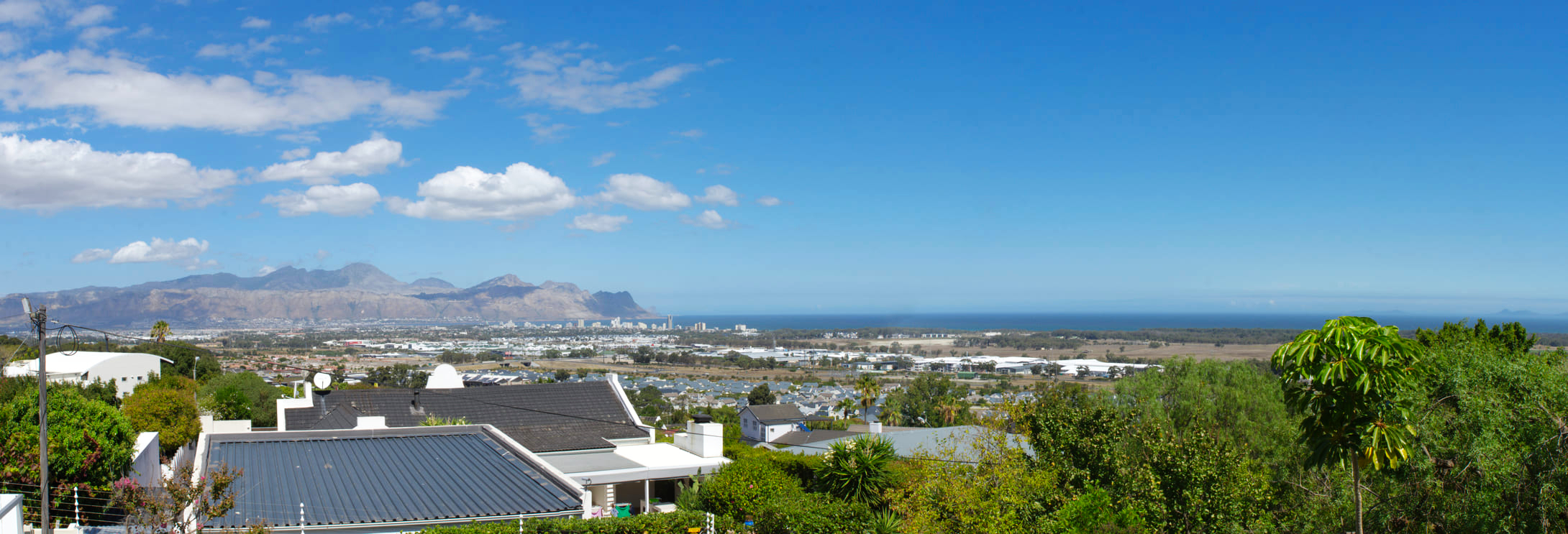 Photo of the view overlooking Strand beachfront and Gordons Bay from the balcony of Somerset View Guest House.