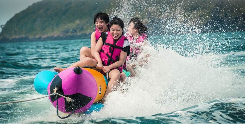 People enjoying banana ride