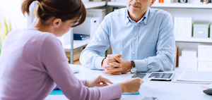 A man and a woman talking to each other during an interview