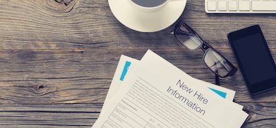 New hire onboarding documents on a table