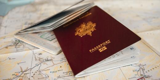Two red UK pre-brexit passports on a table