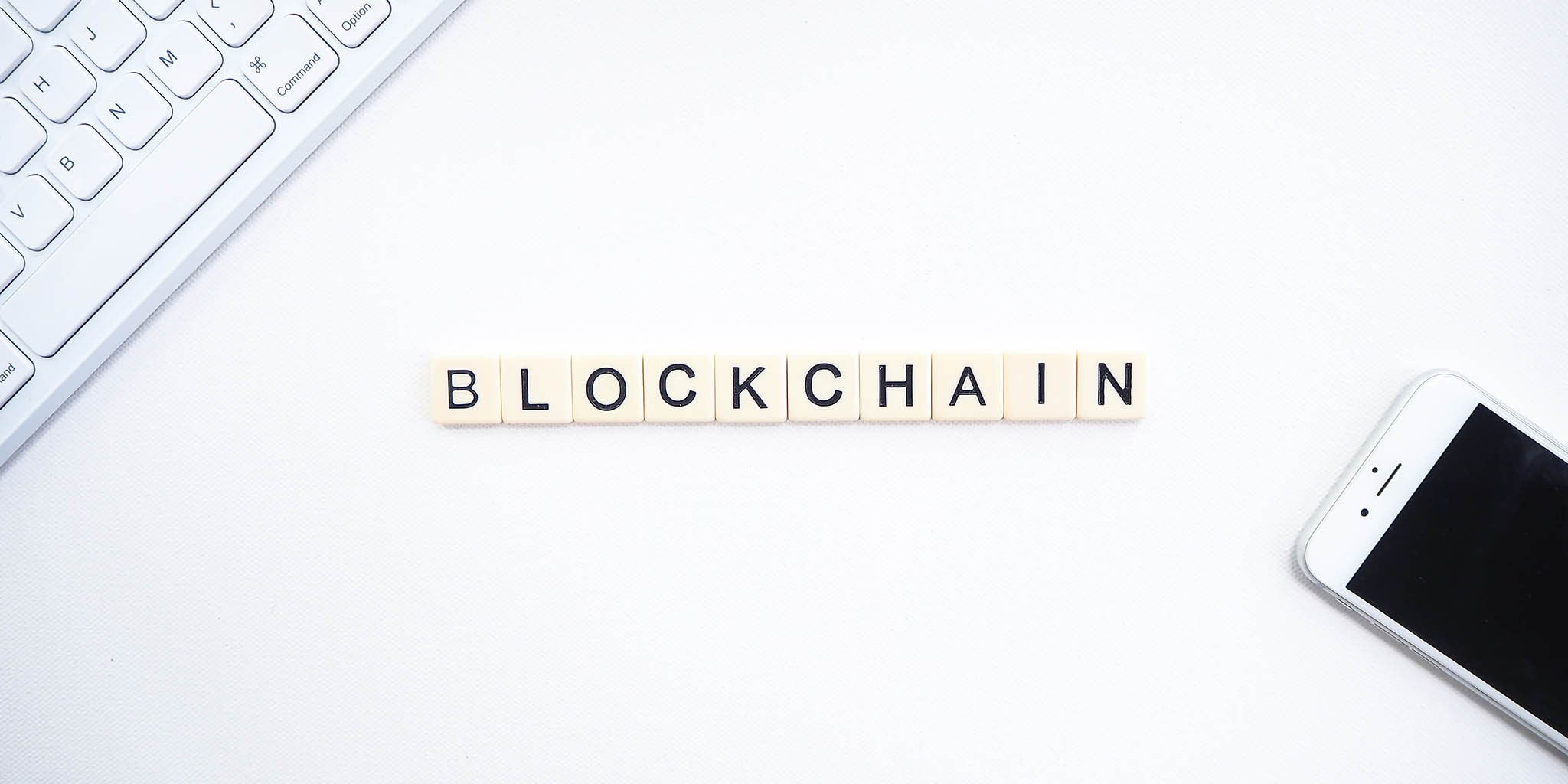 Scrabble tiles placed on a table to spell out Blockchain
