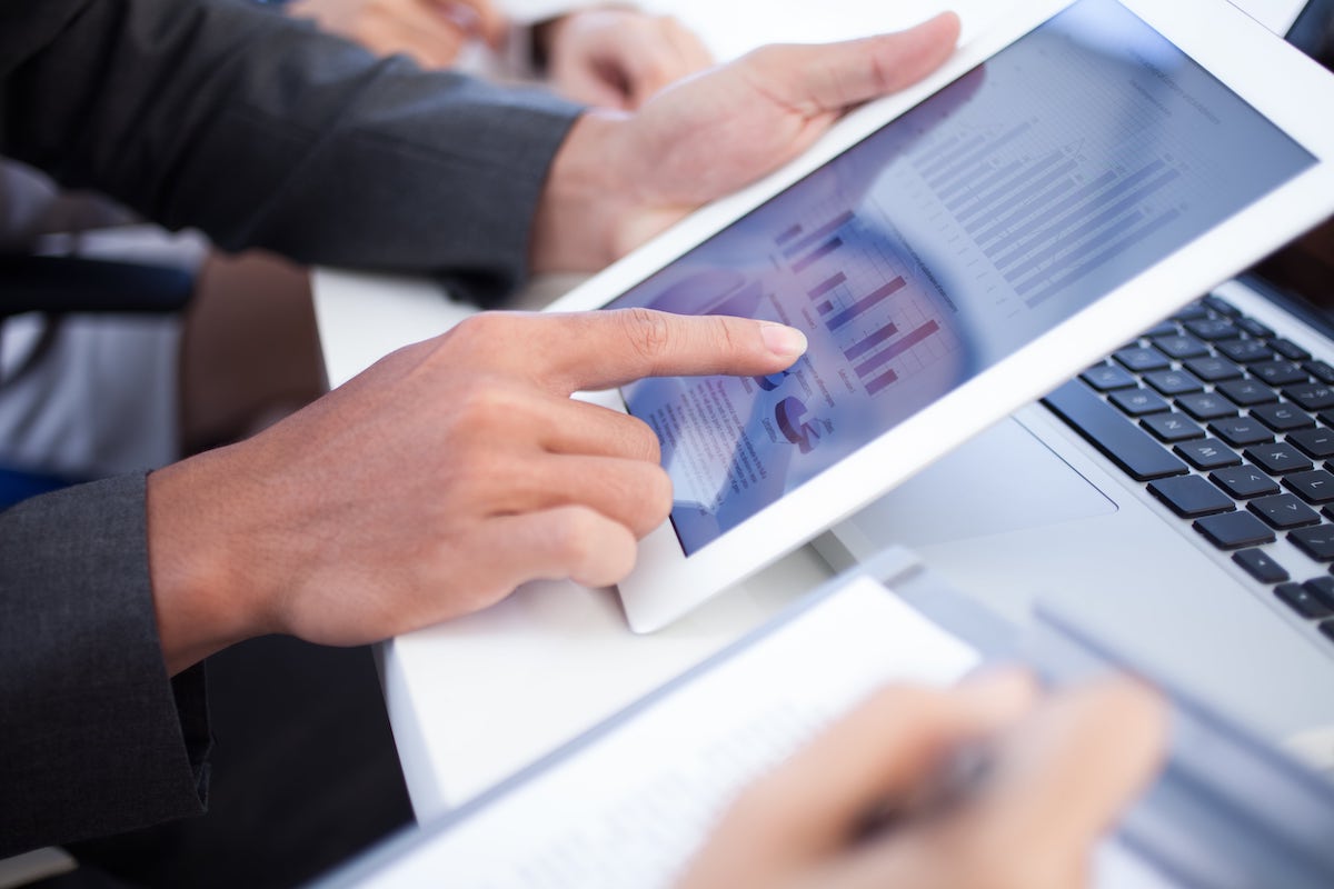 A person showing some charts on a tablet